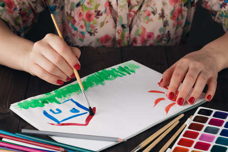 Estate concept, woman draw house and sunの写真素材