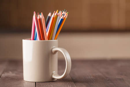 many pencils in mug on wooden tableの写真素材