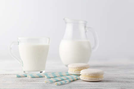 Kid breakfast with milk and white macaroons on tableの写真素材