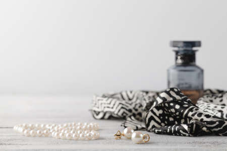 woman scarf on table with parfume and pearl bijouterieの写真素材