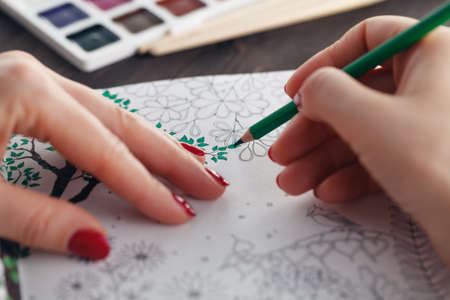 Woman relaxing while do painting adult coloring bookの写真素材