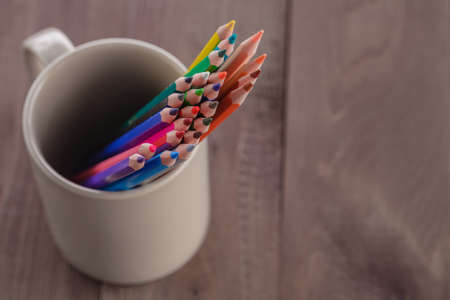 many pencils in mug on wooden tableの写真素材