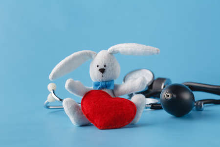 Heart healthcare concept, thonometer and toy heart on blue backgroundの写真素材