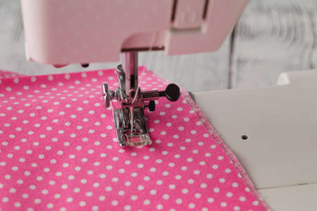 foot of sewing machine with polkadot clothesの写真素材