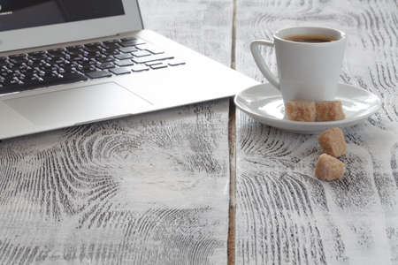 Workplace with laptop and coffeecup on whiteの写真素材