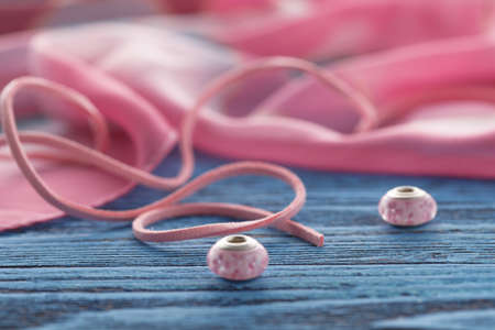 Two ping bead on blue table, concept of handcraftの写真素材