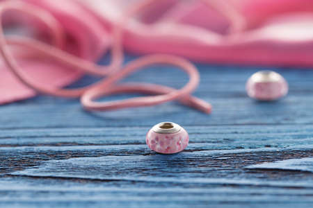 Two ping bead on blue table, concept of handcraftの写真素材