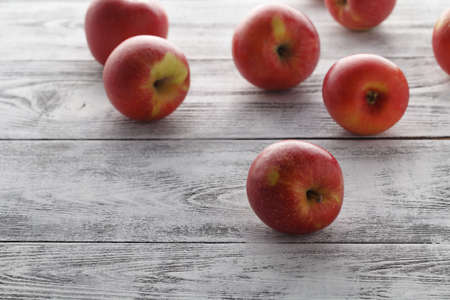 Few red apples lay on wooden table