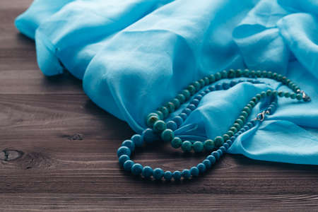 Woman handmade bijouterie made from turquoise beads on shawlの写真素材