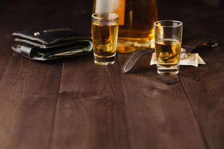 money and whiskey on wooden table. Close-up viewの写真素材