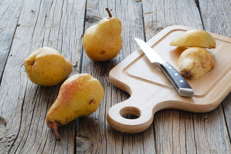 Angelys pear cut in half on cutting boardの写真素材