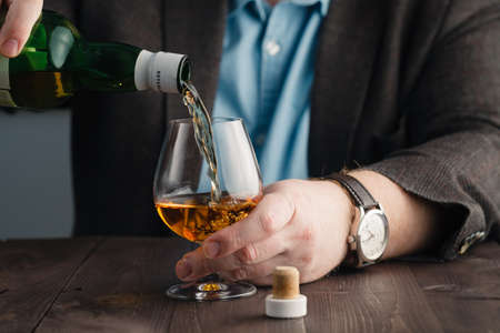 Alcoholism issue, drinking after hard workの写真素材