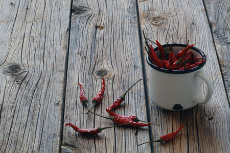 Dried Red hot chili peppers in the metal mug macroの写真素材