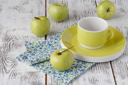 Fresh green apples in a dish on a rustic background.の写真素材
