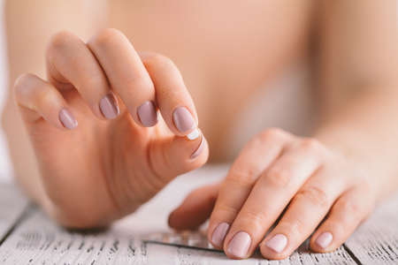 woman holding contraceptive solutions, closeup view