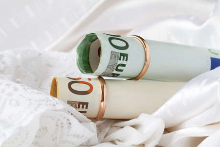Two gold wedding ring dressed on the banknote eurosの写真素材