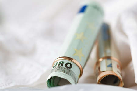 Marriage contract. Two gold wedding rings on the moneyの写真素材