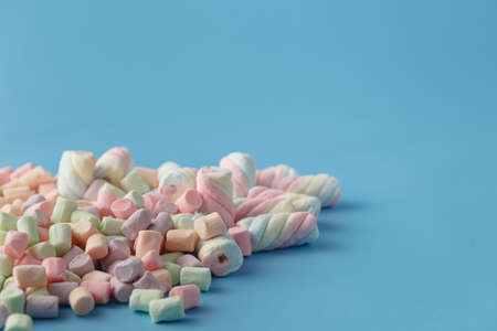 Twisted marshmallow on vibrant blue background