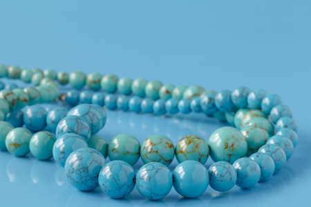 turquoise beads on blue backgroundの写真素材