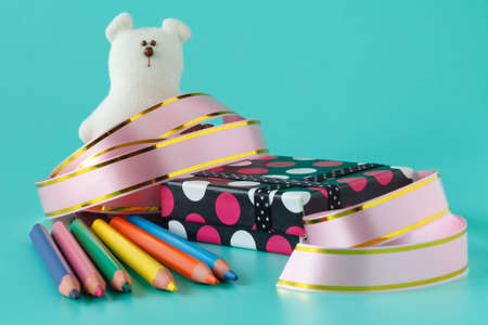 holidays and celebration concept - close up of presents, decoration paper, ribbons and scissorsの写真素材