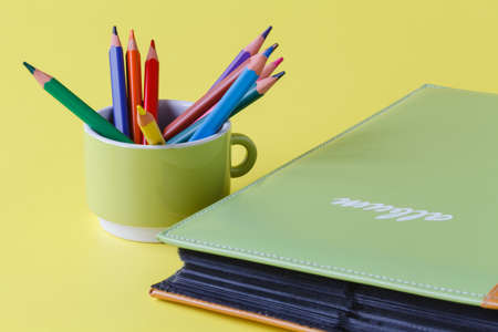 Photo album book on yellow backgroundの写真素材