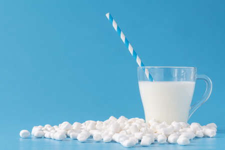 Fresh glass of milk on blue backgroundの写真素材