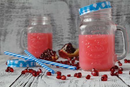 Pomegranate and orange winter or autumn cocktail, punch or sangria in mason jarの写真素材