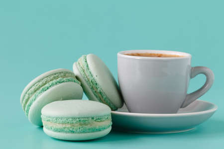 French macarons and coffee cup on aquamarine backgroundの写真素材