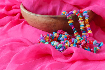 ethnic gem bijouterie lay on pink silk shawlの写真素材