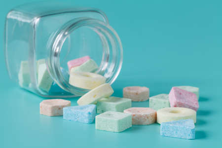 Candy in glass jar on blue background. Close upの写真素材