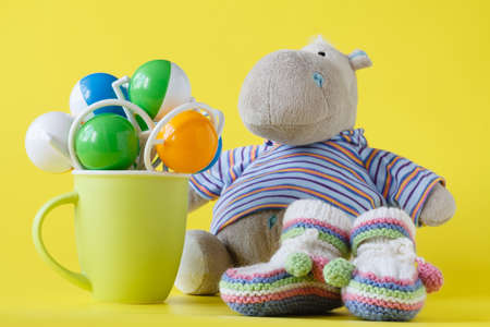 Hippopotamus toy and green cupの写真素材