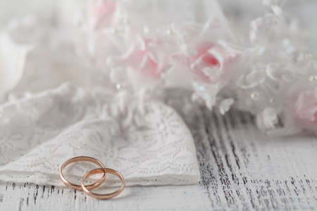Wedding rings on lace backgroundの写真素材