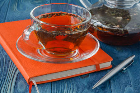 Herbal tea in a glass tea potの写真素材