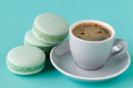 French macarons and coffee cup on aquamarine backgroundの写真素材