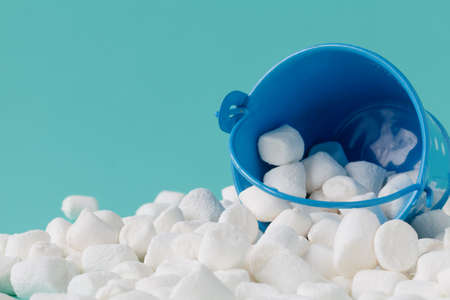 Marshmallow in basket on blue background. Close upの写真素材