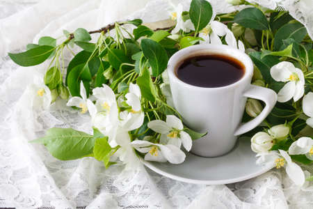 Cup of hot tasty coffee in very spring floral setting. Full of white and very cute pink color. Romantic decor elementsの写真素材