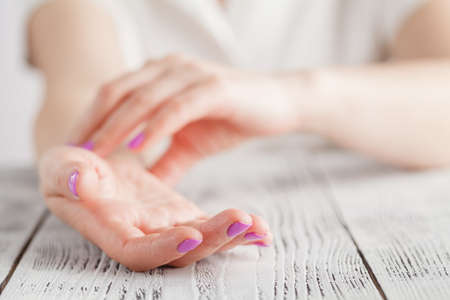 Medicine health care. Female hand checking pulse on wrist closeupの写真素材