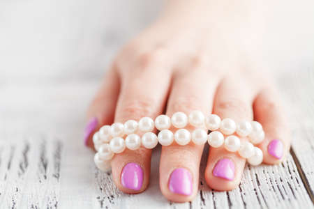 Female hands with manicure closeup on light backgroundの写真素材