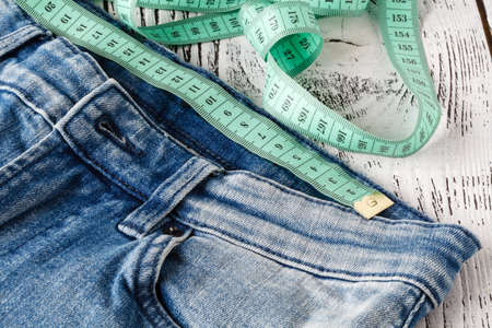 Jeans with measuring tapeの写真素材