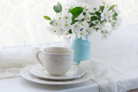 Cup of green tea and japanese cherry blossom on blue backgroundの写真素材