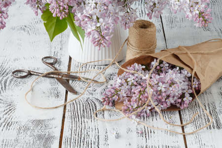 Beautiful lilac flowers in paper bagの写真素材