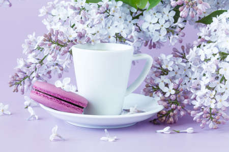 Cup of coffee and branches of blooming lilacの写真素材