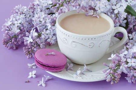 Romantic background with cup of tea, lilac flowersの写真素材