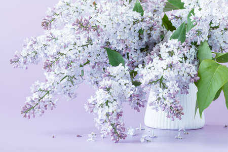 Vase with a branch of lilac flower