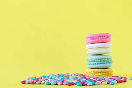 Sweet and colorful French macarons on yellow backgroundの写真素材