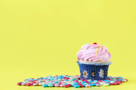 Tasty cupcakes with candles on colorful backgroundの写真素材