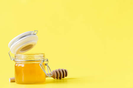 jar of honey, lemon and wooden drizzler