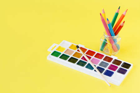 Use watercolor paints box on yellow backgroundの写真素材