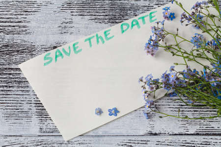 The forget-me-not branch on a card with pgrase save the dateの写真素材