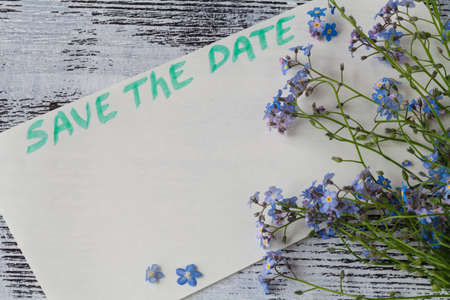 The forget-me-not branch on a card with pgrase save the dateの写真素材